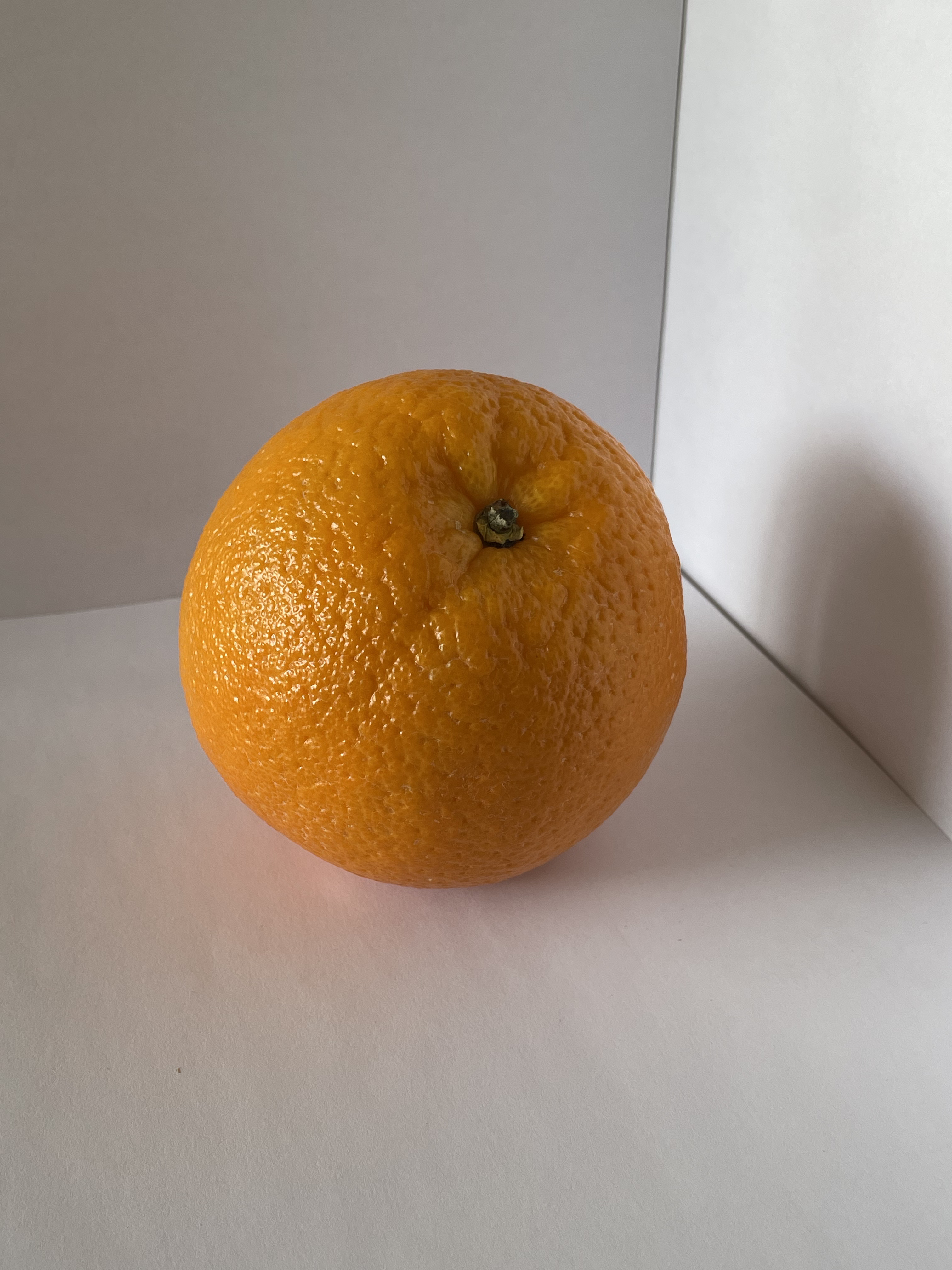 The front view of an orange from an angle.