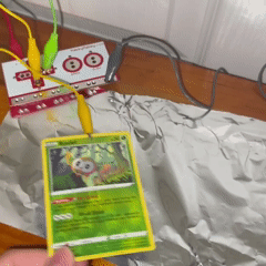 I grabbed some pokemon cards and aluminum foil to create an interaction when you place the card down on the conductive surface (connected to teh ground). I placed aluminum foil behind the cards so then when the two surfaces touch, it will trigger a sound.